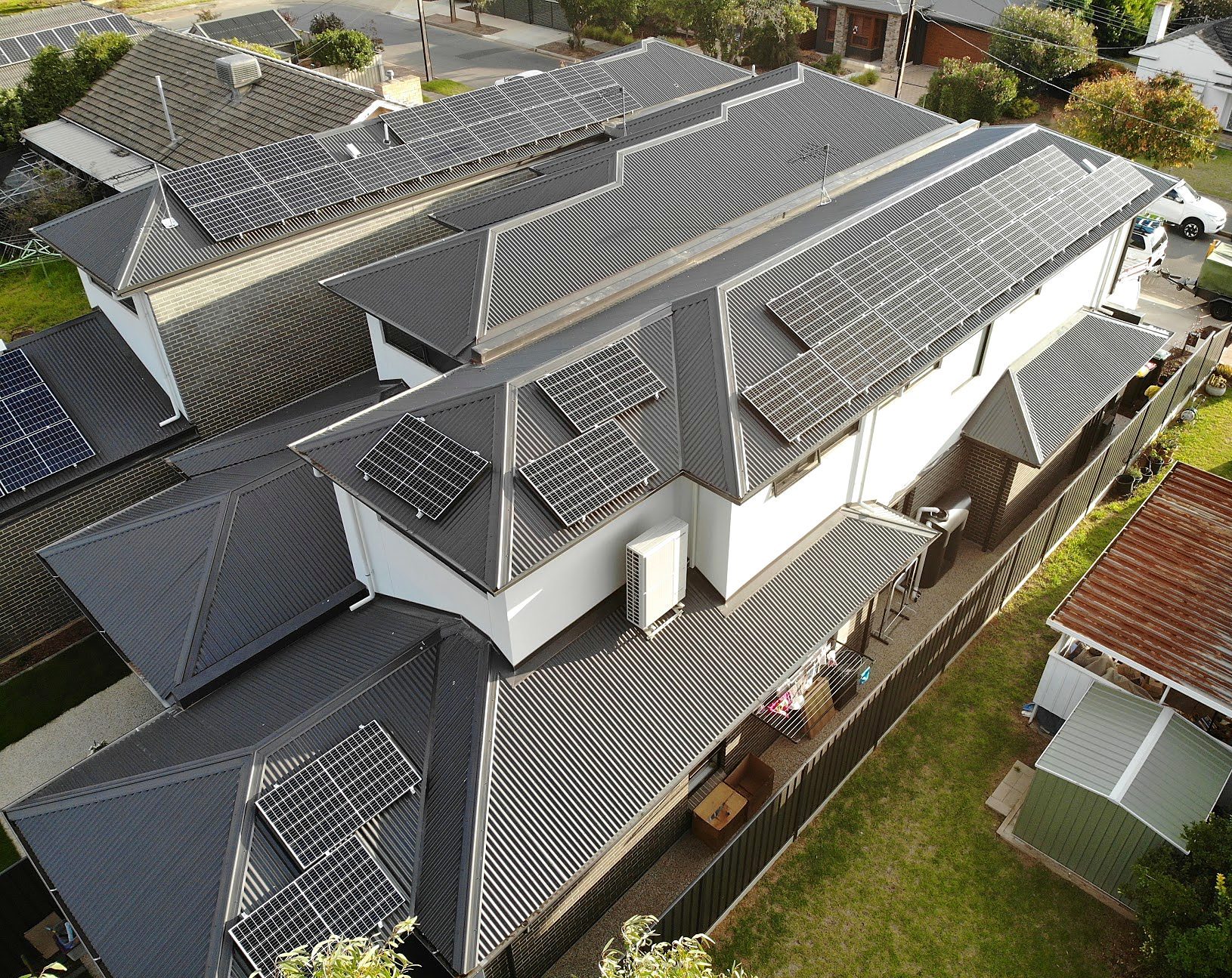 Aerial view of rooftop solar panels installed across a two-storey home.